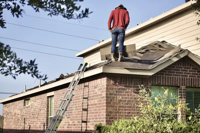 Professional roofer working on a residential roof in East Schuyler